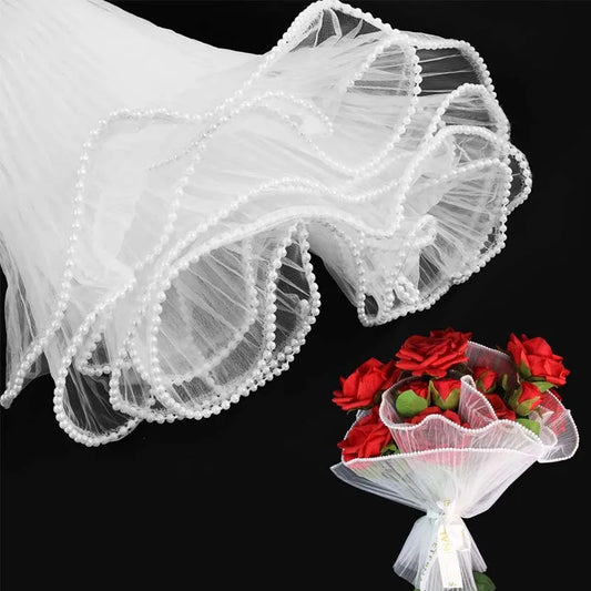 White Floral Packaging for Bouquets Including Decorative Mesh Wrapping